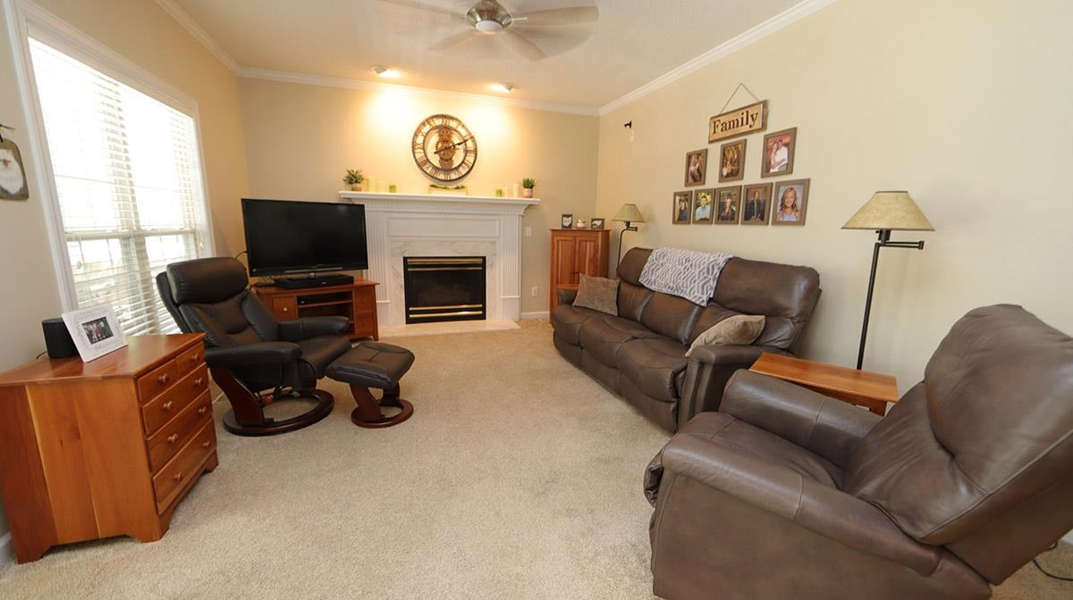 3820 Evander Way Raleigh, NC 27613 - Photo 15 of 30 The family room is open to the kitchen and is really cozy. There is a gas log fireplace with impressive mantel and surround. The room is wired for speakers as well. Family Room