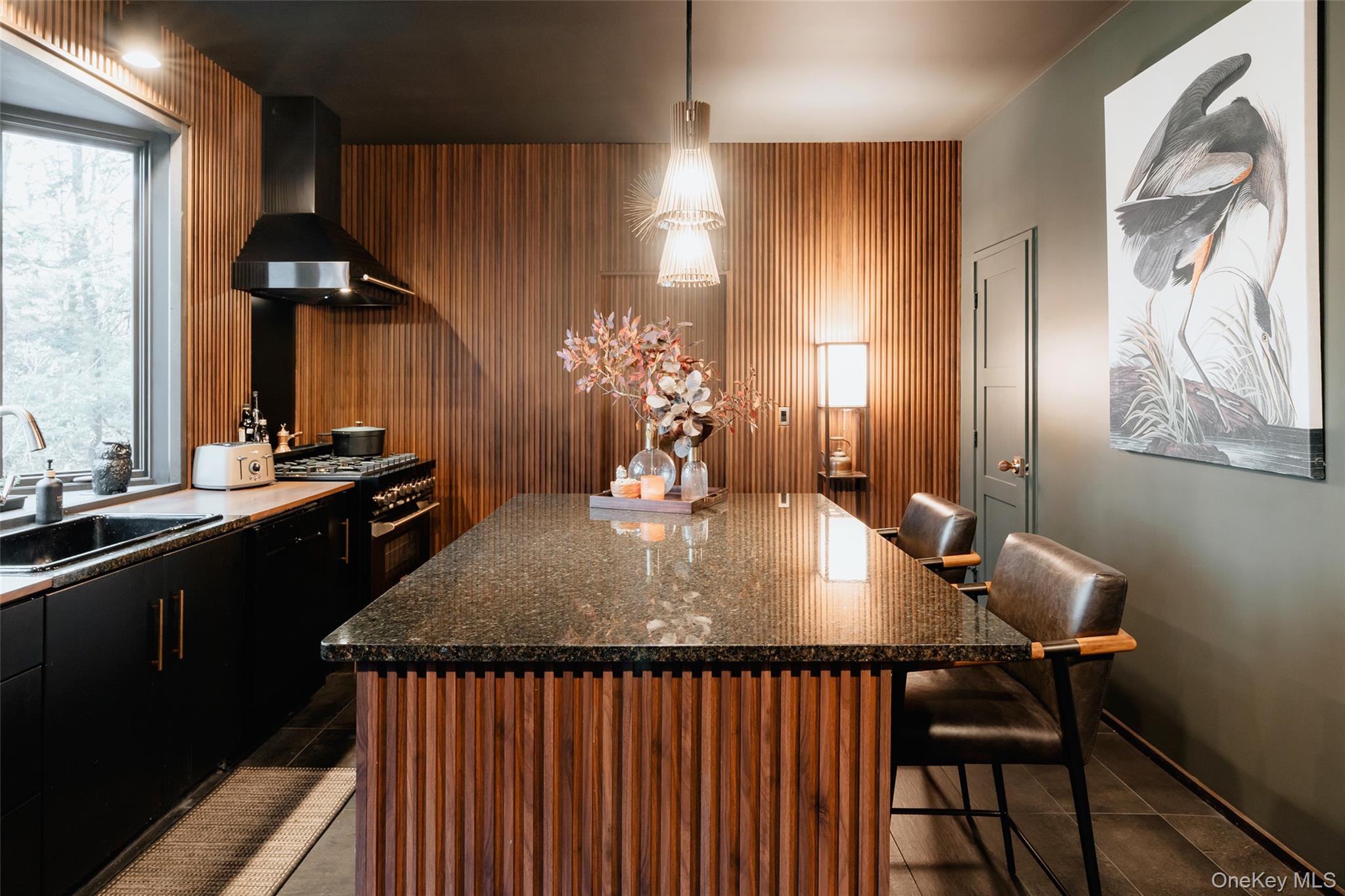 521 Perry Road Swan Lake, NY 12783 - Photo 11 of 32 a kitchen with a table chairs and wooden floor