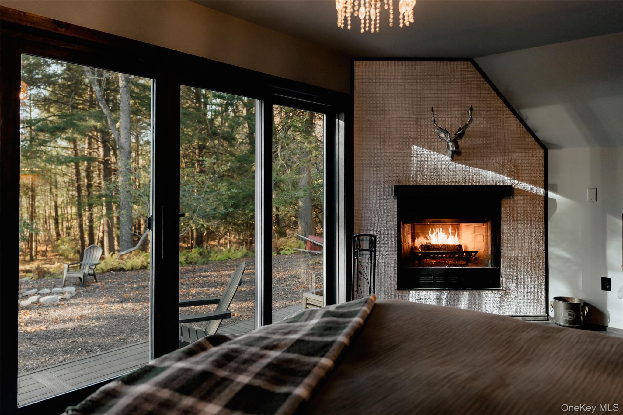 521 Perry Road Swan Lake, NY 12783 - Photo 17 of 32 a living room with a fireplace and a floor to ceiling window