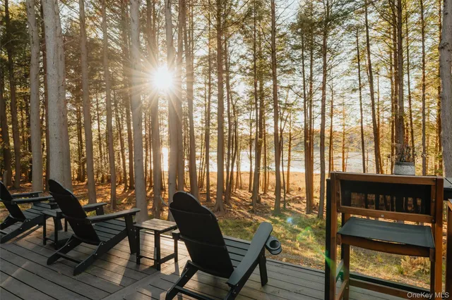 a living room with furniture and large windows