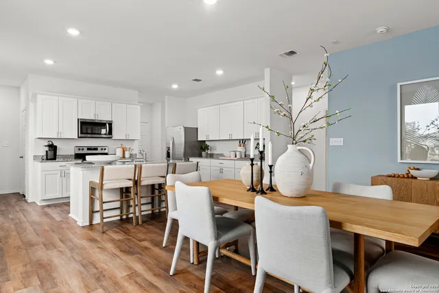 a view of a dining room with furniture and wooden floor