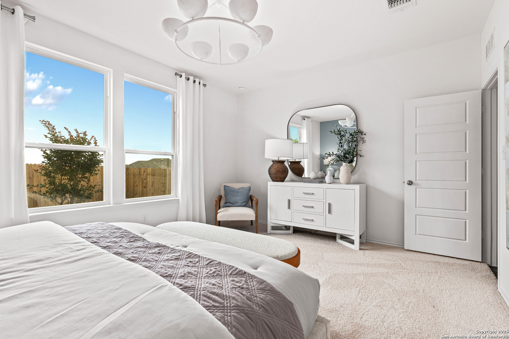 405 Raven Row Marion, TX 78124 - Photo 2 of 25 a bedroom with a bed and a large mirror on the dresser