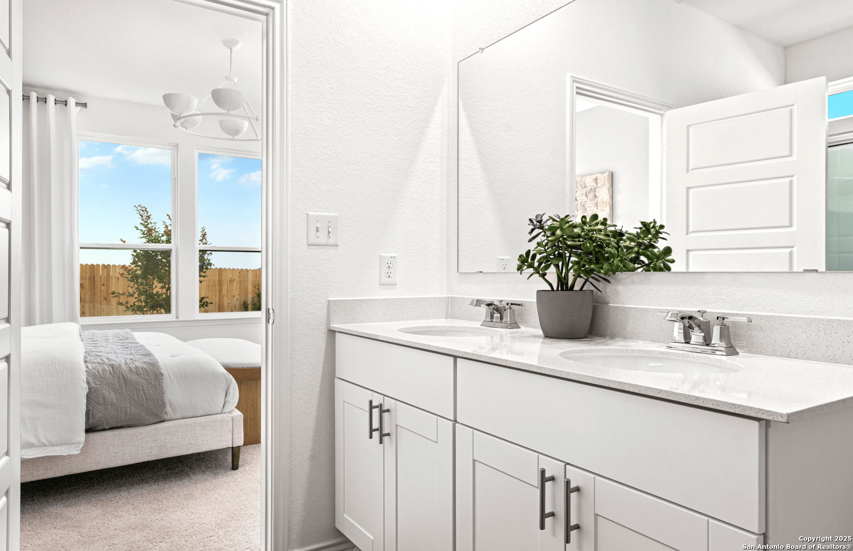 405 Raven Row Marion, TX 78124 - Photo 7 of 25 a en suite bathroom with a double vanity sink and mirror