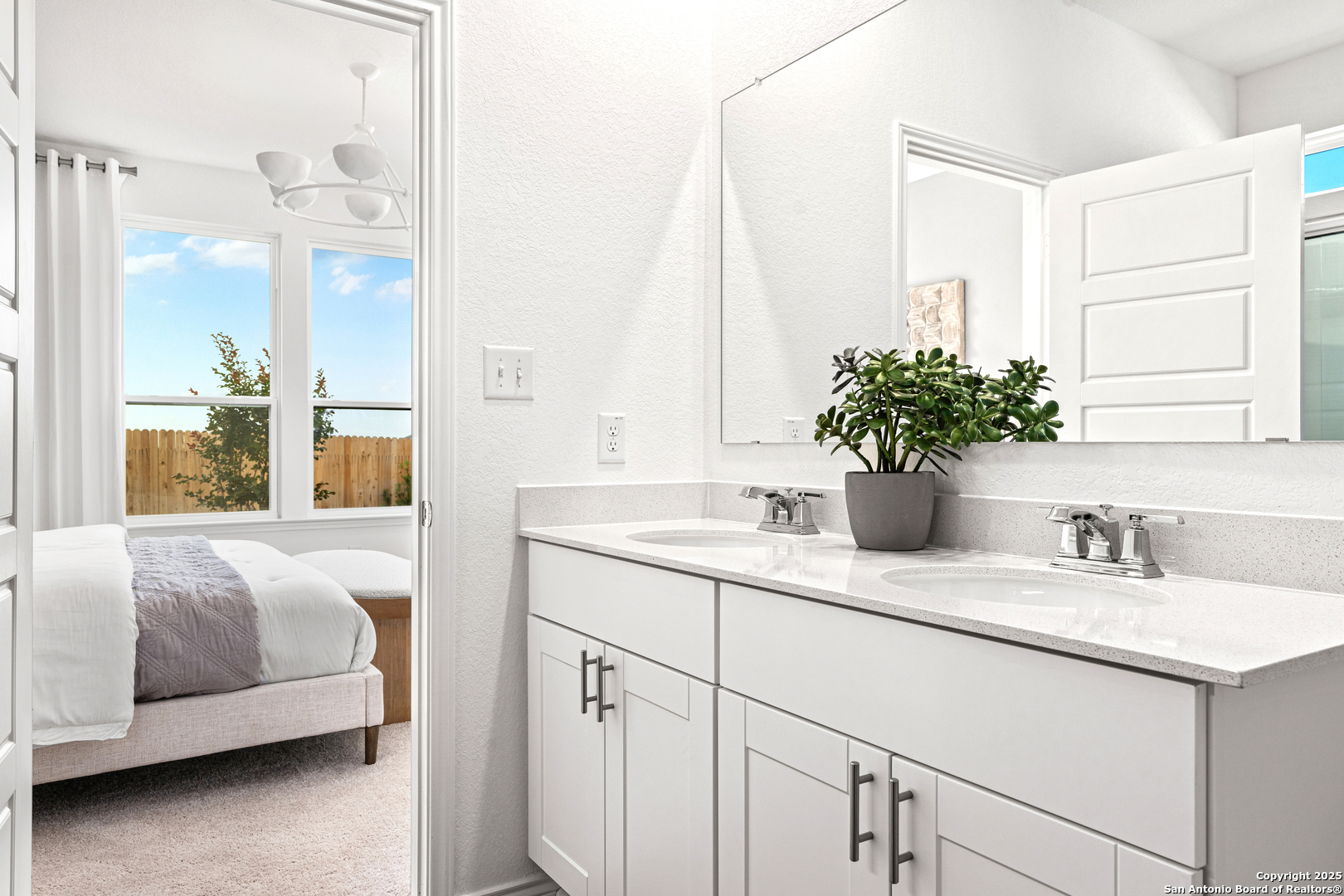 405 Raven Row Marion, TX 78124 - Photo 8 of 25 a en suite bathroom with a double vanity sink and mirror