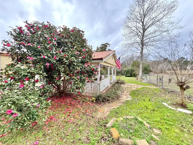 a front view of a house with a yard and fountain