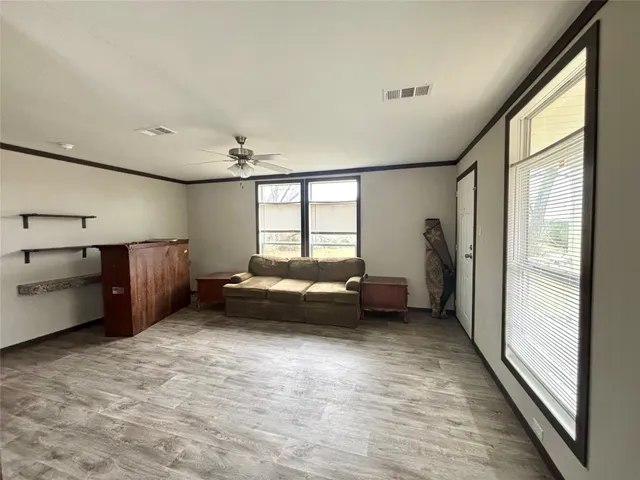 a kitchen with stainless steel appliances granite countertop a sink a stove a microwave and wooden cabinets