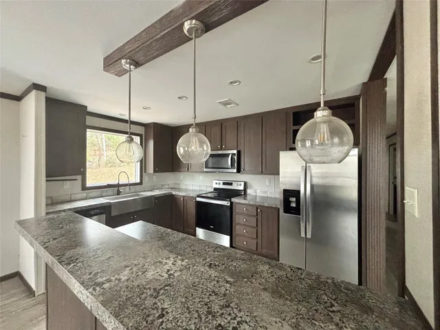 a view of a livingroom with wooden floor and windows