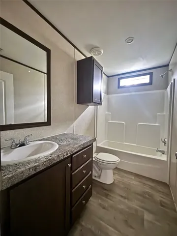 a view of an empty room with a ceiling fan