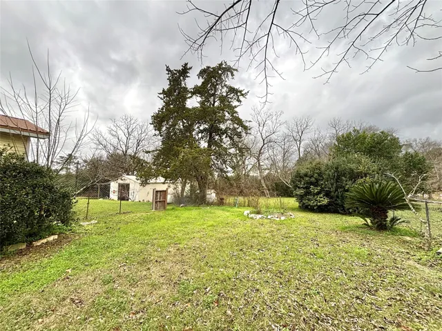 a view of a yard with a house in the background