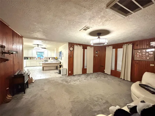 a view of a livingroom with furniture and a ceiling fan