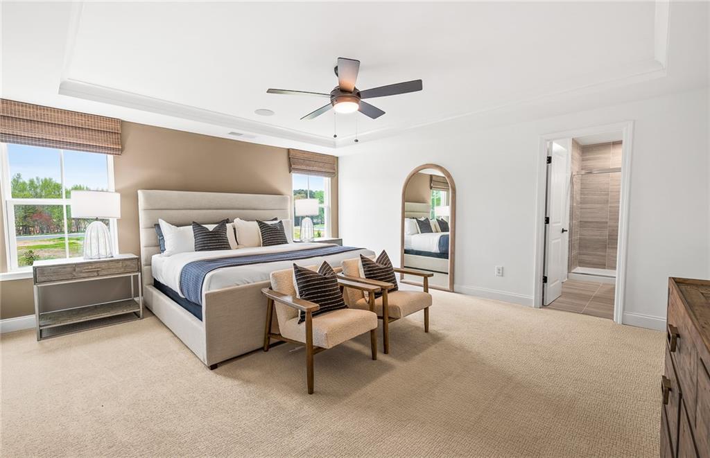 421 Beacon Way Villa Rica, GA 30180 - Photo 23 of 36 a bedroom with a bed and a chandelier