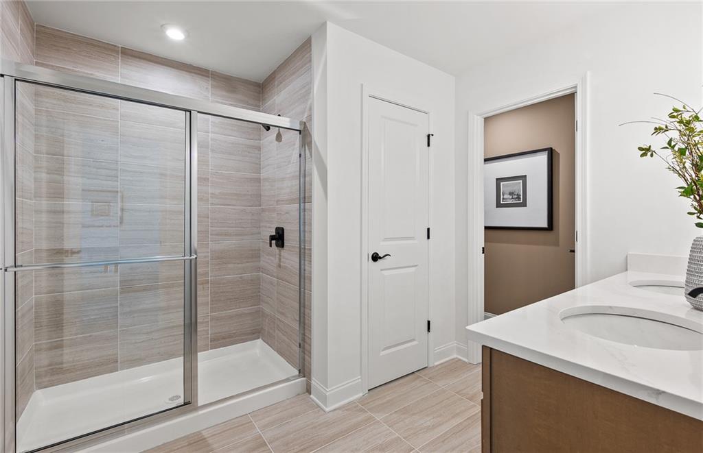 421 Beacon Way Villa Rica, GA 30180 - Photo 24 of 36 a bathroom with a shower sink and mirror