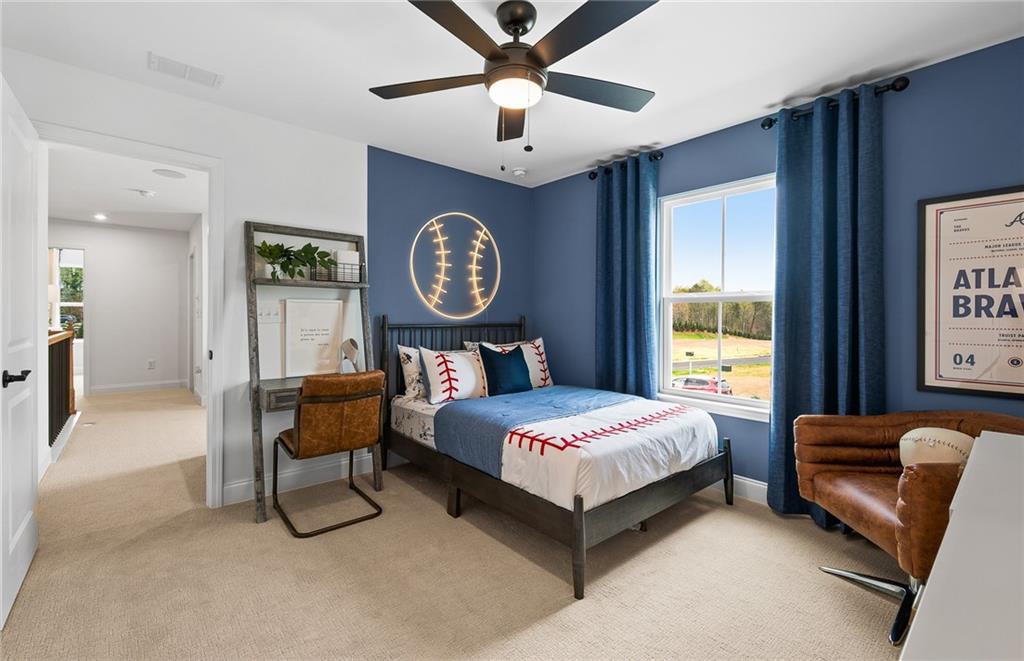 421 Beacon Way Villa Rica, GA 30180 - Photo 34 of 36 a bedroom with a bed and a chandelier