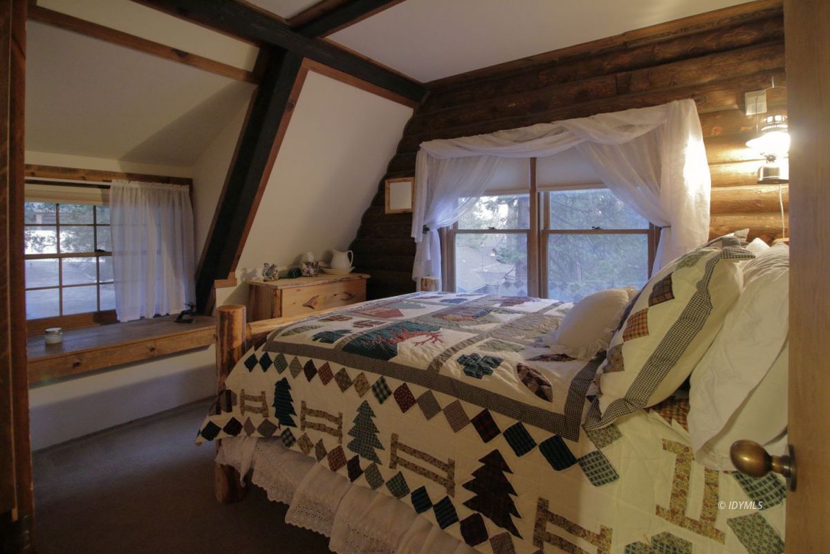 24745 Fern Valley Road Idyllwild, CA 92549 - Photo 20 of 48 a bed sitting in a bedroom next to a window