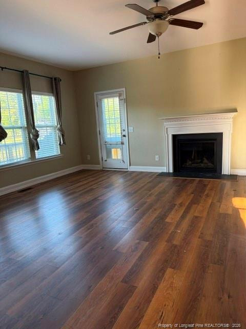 1284 L L Cooper Road Cameron, NC 28326 - Photo 4 of 24 an empty room with wooden floor fireplace and windows