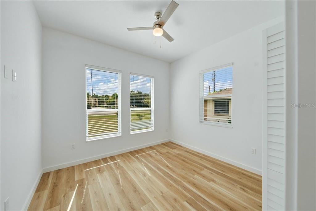 1215 Rio De Janeiro Avenue Punta Gorda, FL 33983 - Photo 53 of 65 a view of empty room with wooden floor and fan
