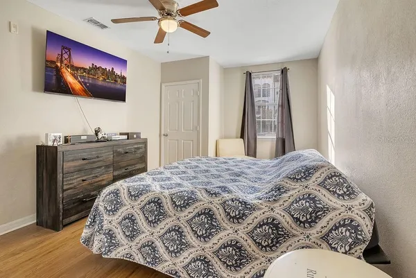 a bedroom with a bed and a flat screen tv