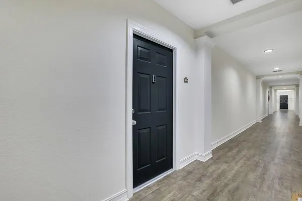 a view of hallway with wooden floor