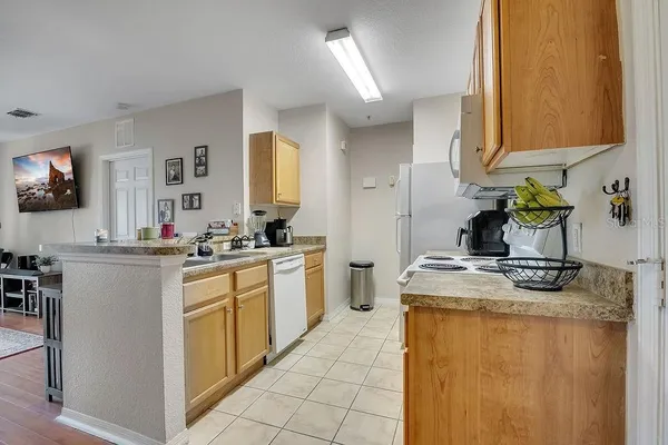a kitchen with kitchen island sink stove and cabinets