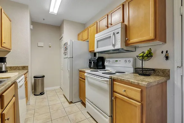 a kitchen with a stove a sink and a refrigerator