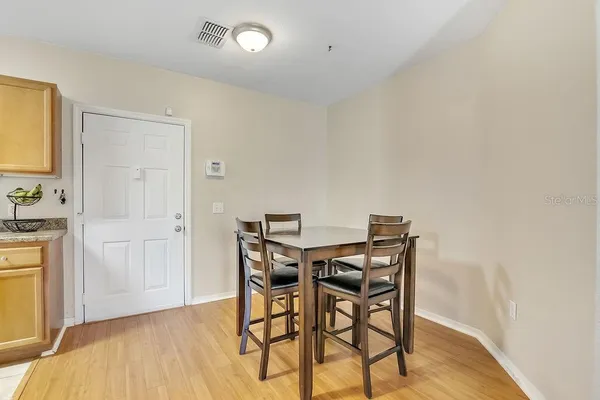 a view of a dining room with furniture and wooden floor