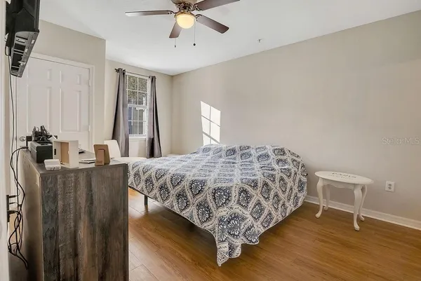 a bedroom with a bed and a chandelier