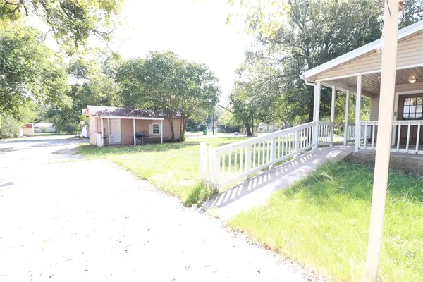a view of a house with pool and sitting area
