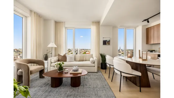 a living room with furniture a large window and a table