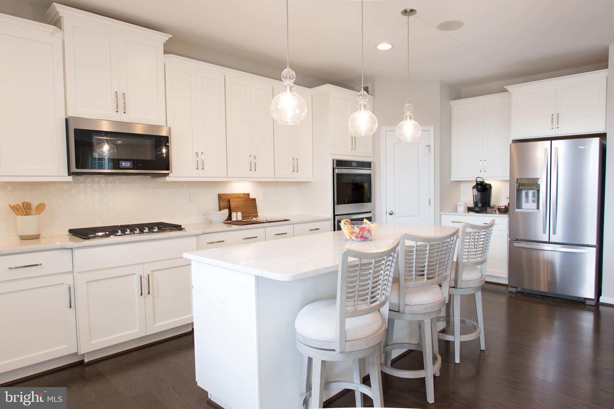 Tbb Tbb Marquee Farm Road, Unit CYPRESS Charles Town, WV 25414 - Photo 2 of 30 a kitchen with stainless steel appliances a stove a sink refrigerator and white cabinets with wooden floor