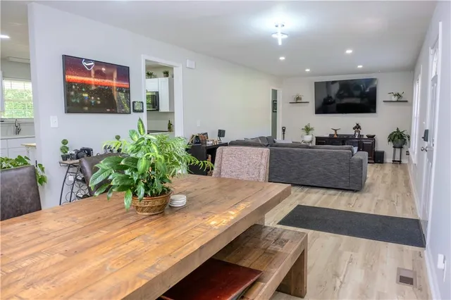 a hallway with furniture and a potted plant