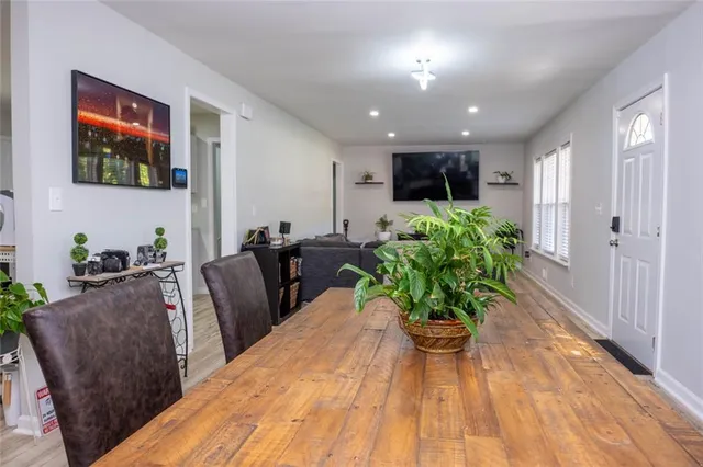 a living room with furniture potted plant and a flat screen tv