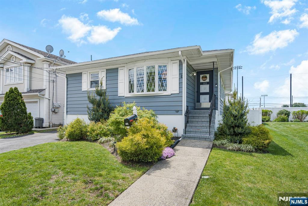 112 Garibaldi Avenue Lodi, NJ 07644 - Photo 1 of 31 a front view of a house with garden