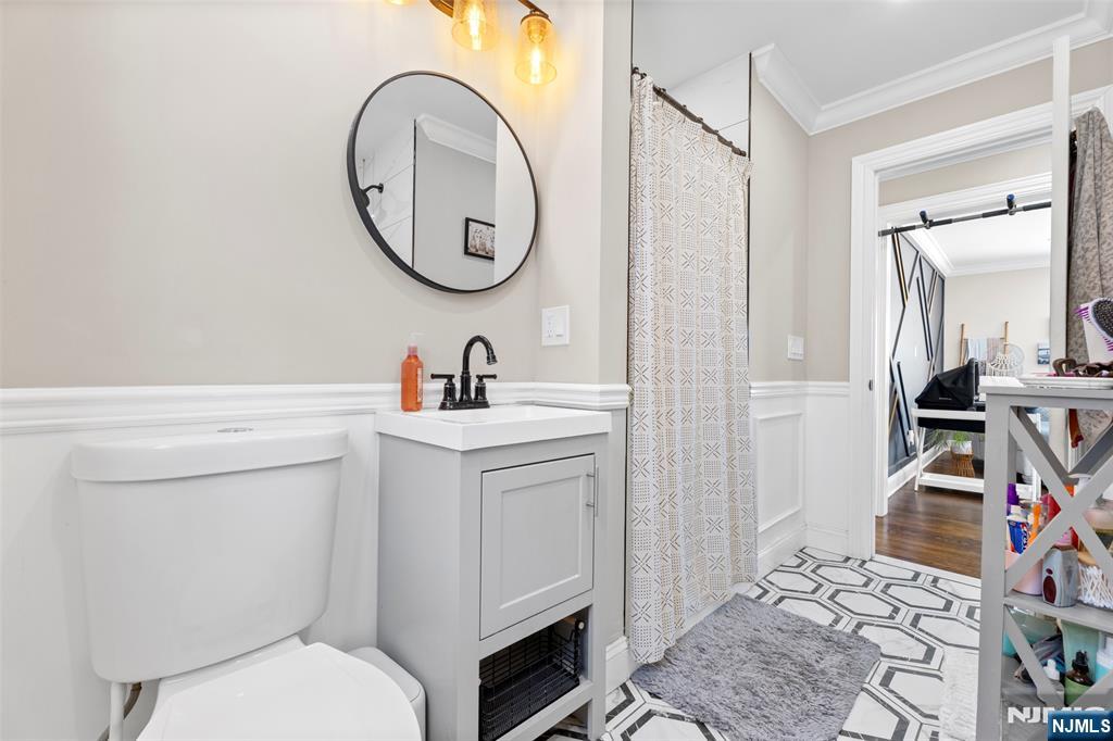 112 Garibaldi Avenue Lodi, NJ 07644 - Photo 11 of 31 a bathroom with a toilet sink and mirror