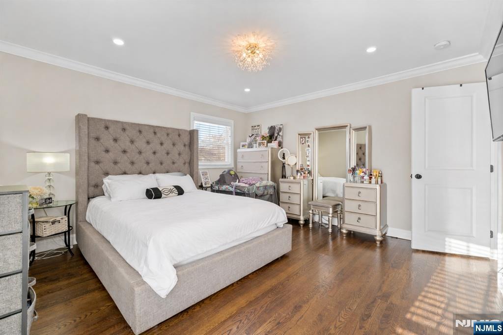 112 Garibaldi Avenue Lodi, NJ 07644 - Photo 12 of 31 a bedroom with a bed and a chandelier