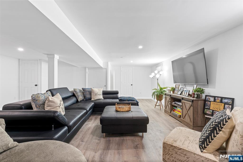 112 Garibaldi Avenue Lodi, NJ 07644 - Photo 15 of 31 a living room with furniture and a wooden floor