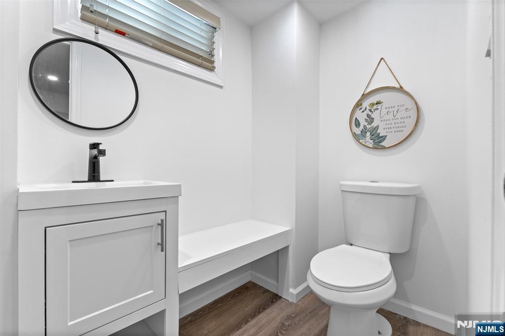 112 Garibaldi Avenue Lodi, NJ 07644 - Photo 16 of 31 a bathroom with a toilet a sink and a mirror