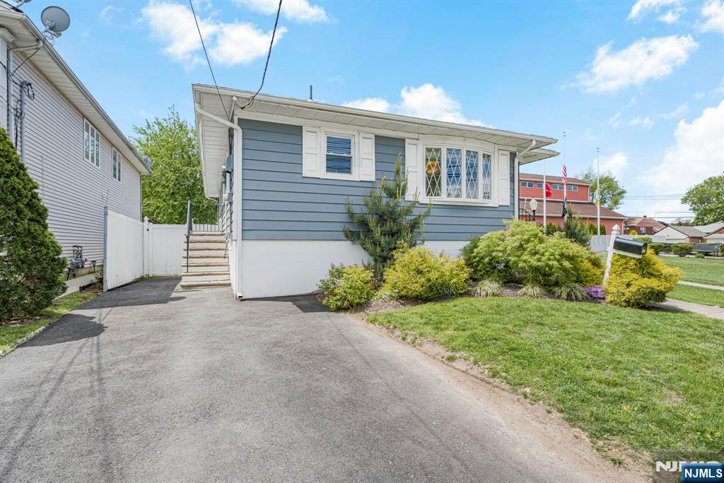 112 Garibaldi Avenue Lodi, NJ 07644 - Photo 2 of 31 a house view with a garden space