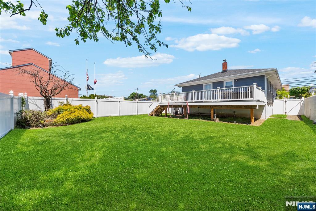 112 Garibaldi Avenue Lodi, NJ 07644 - Photo 22 of 31 a front view of a house with a yard table and chairs