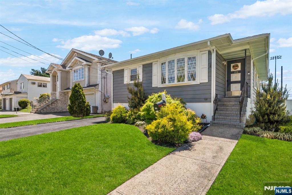 112 Garibaldi Avenue Lodi, NJ 07644 - Photo 30 of 31 a front view of a house with garden