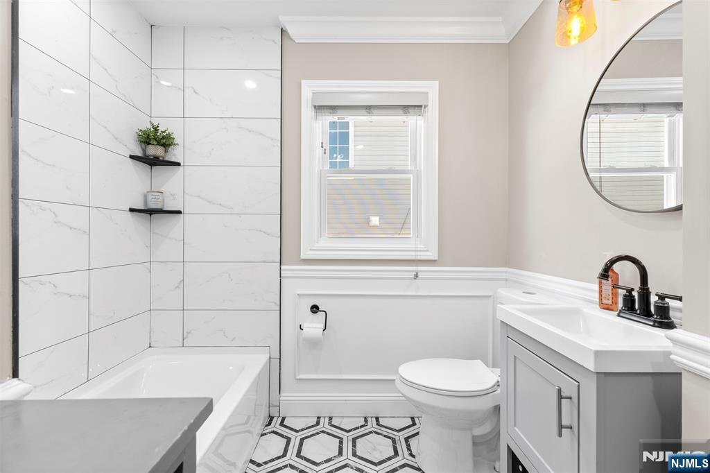 112 Garibaldi Avenue Lodi, NJ 07644 - Photo 10 of 31 a bathroom with a sink a toilet and bathtub