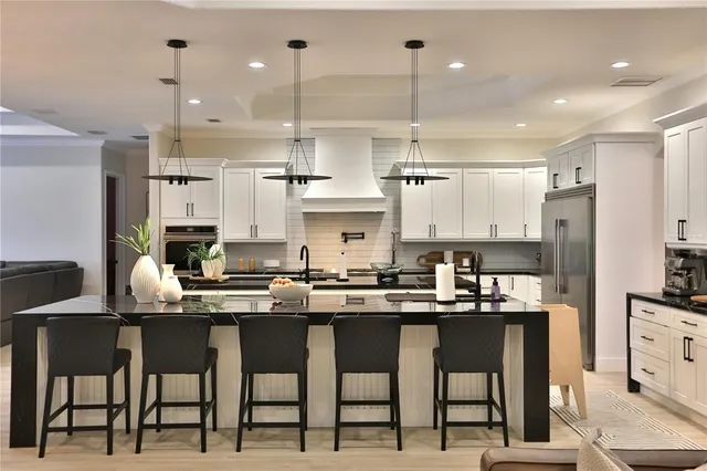 a kitchen with cabinets and chairs