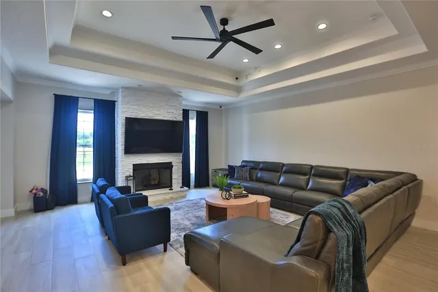 a living room with furniture fireplace and a chandelier
