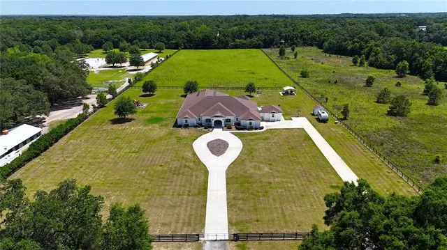 an aerial view of a house with a swimming pool