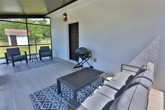 a living room with furniture rug and wooden floor