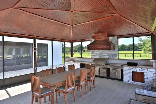 a dining room with a large window table and chairs