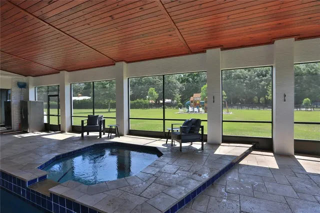 a swimming pool with outdoor seating