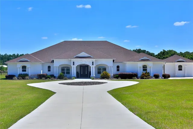 a front view of house with yard and green space