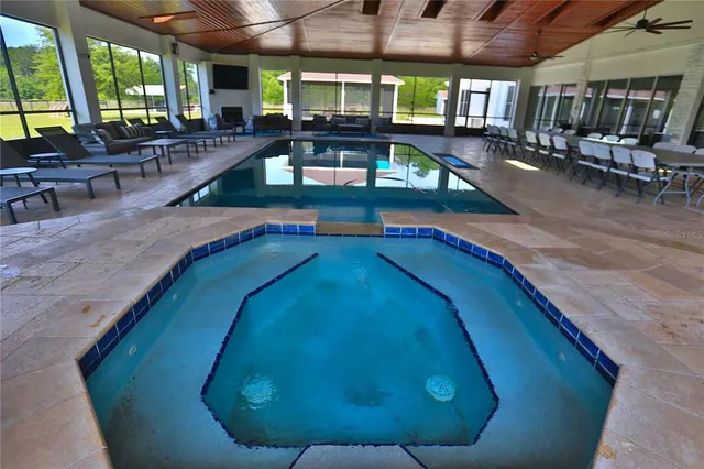 a view of a swimming pool with outdoor seating