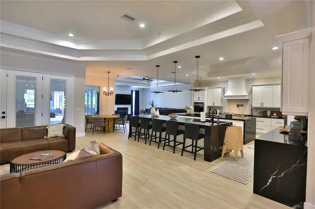 a living room with lots of furniture and kitchen view
