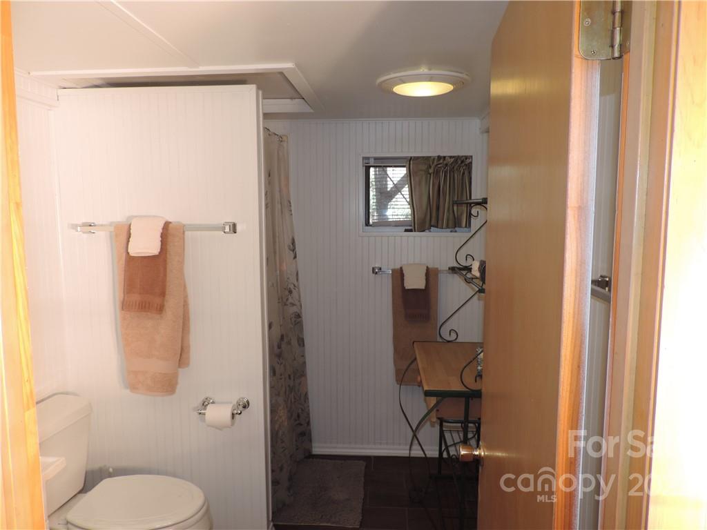 3284 Lake Logan Road Canton, NC 28716 - Photo 22 of 44 a bathroom with a toilet and a shower